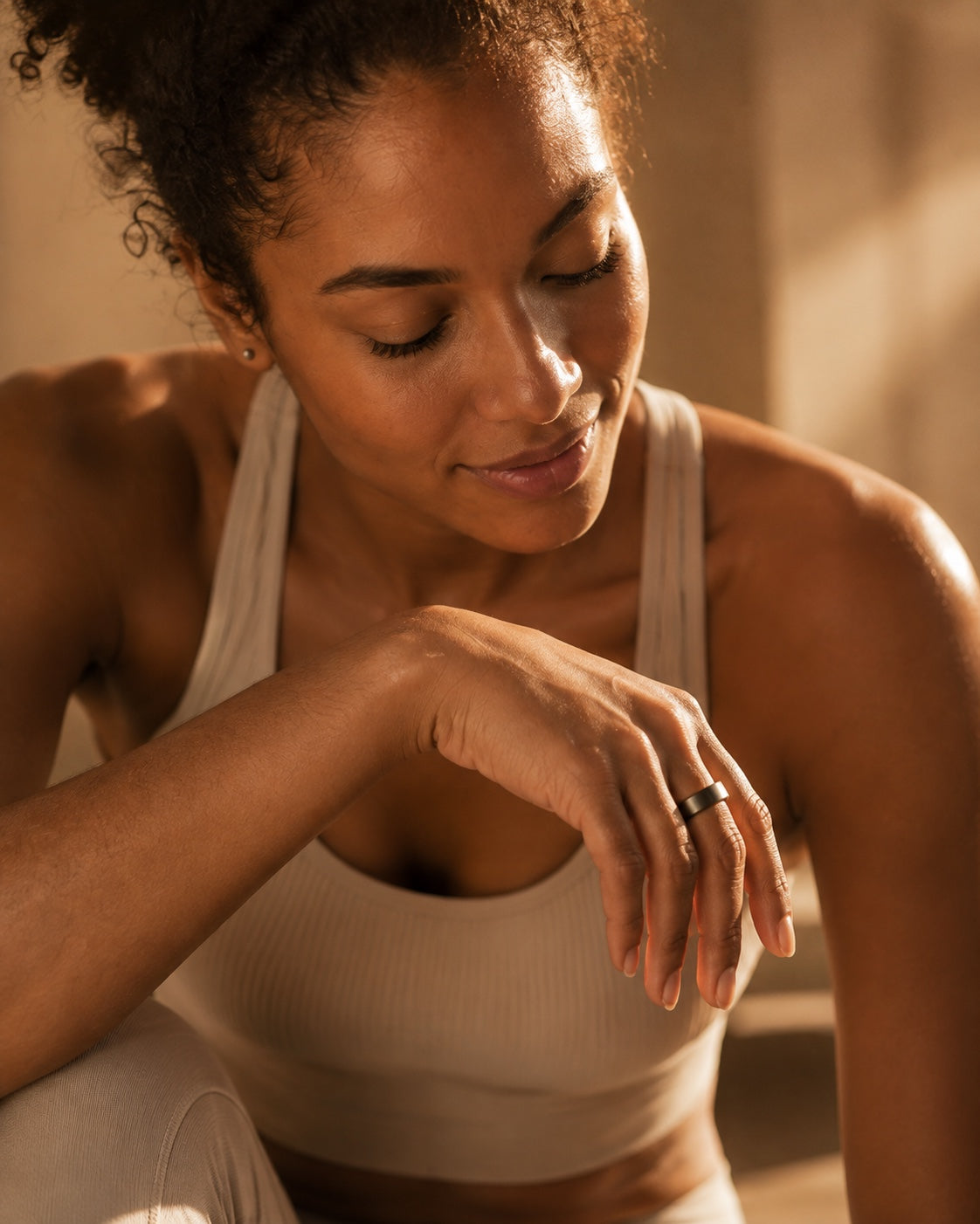 Woman wearing a silver Suna Ring in warm morning light